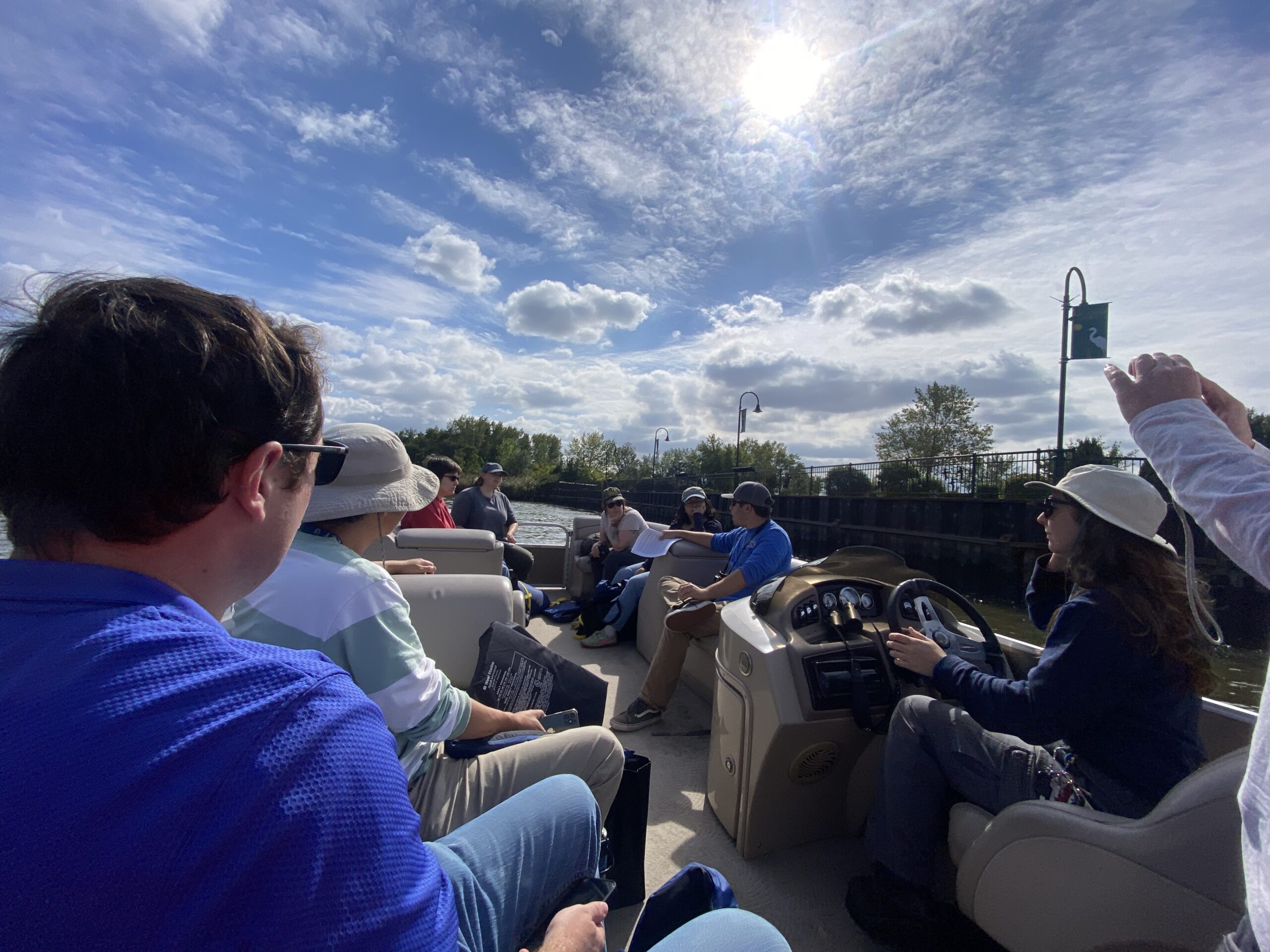 A group tours a marsh aboard a small boat